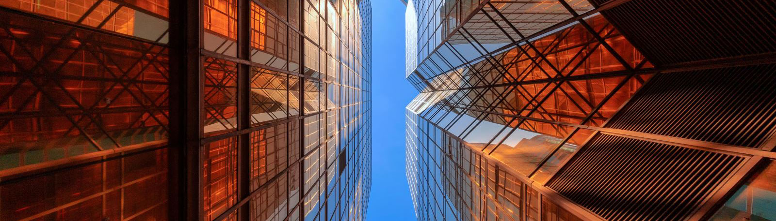 Worms eye view between two glass buildings