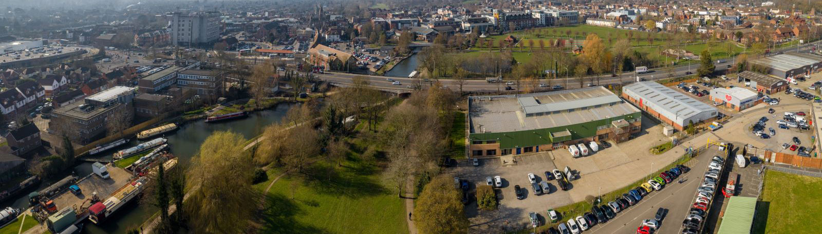 Aerial view of warehouses with a canal and boats running to the left