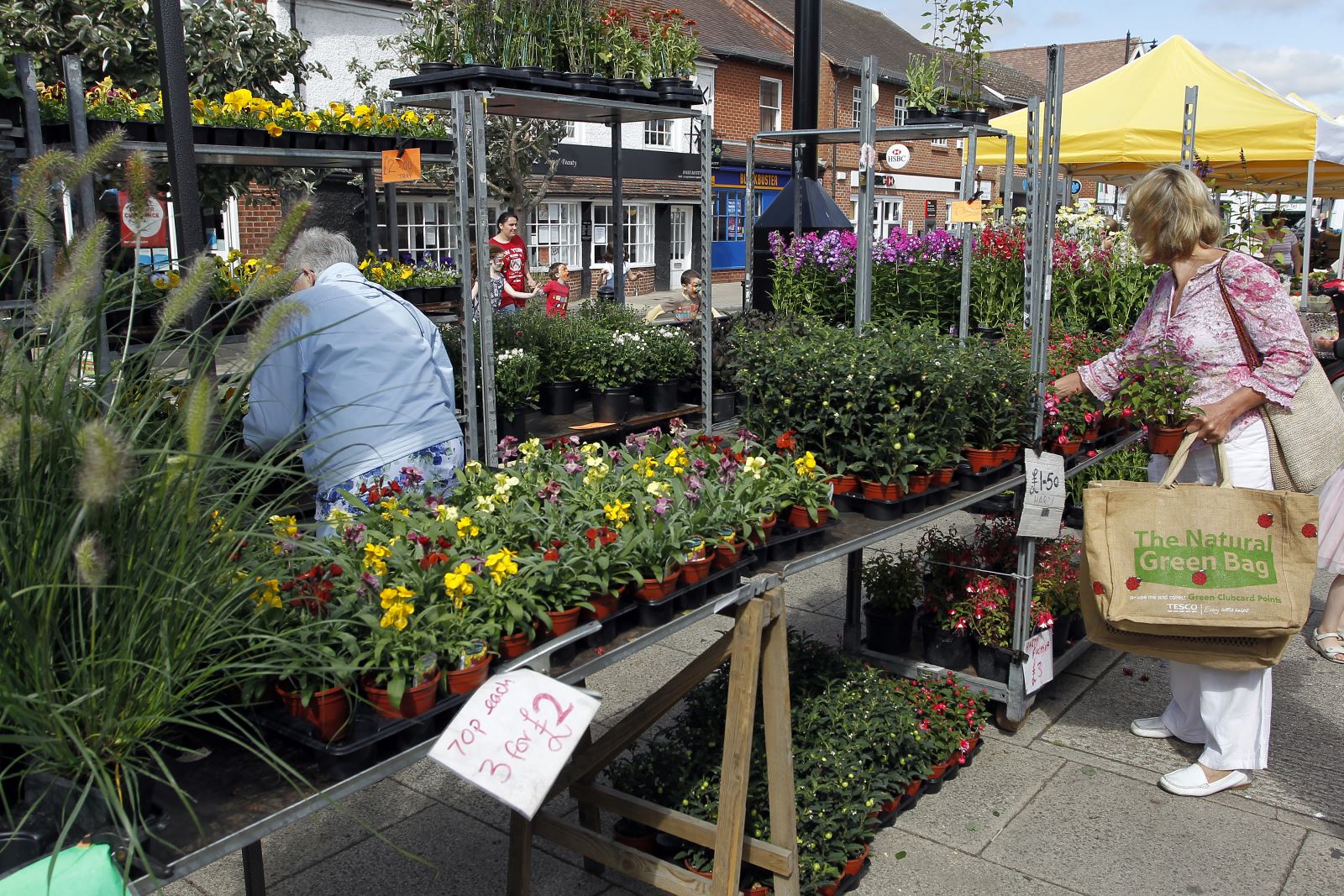 flower stall at market with shopper